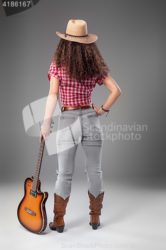 Image of The cowgirl fashion woman over a gray background