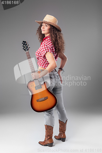 Image of The cowgirl fashion woman over a gray background