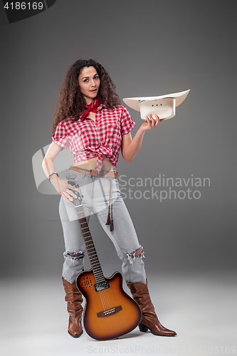 Image of The cowgirl fashion woman over a gray background