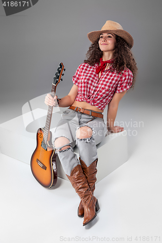 Image of The cowgirl fashion woman over a gray background