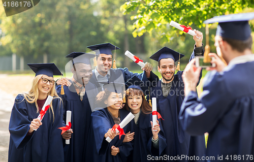 Image of students or bachelors photographing by smartphone