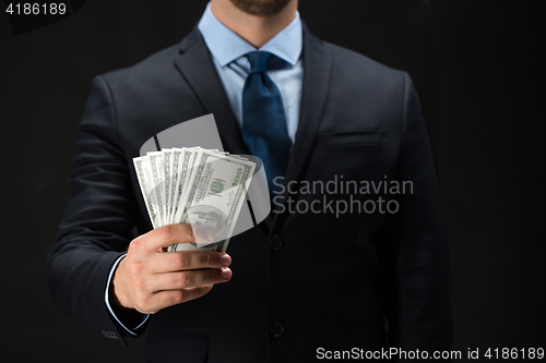 Image of close up of businessman hands holding money