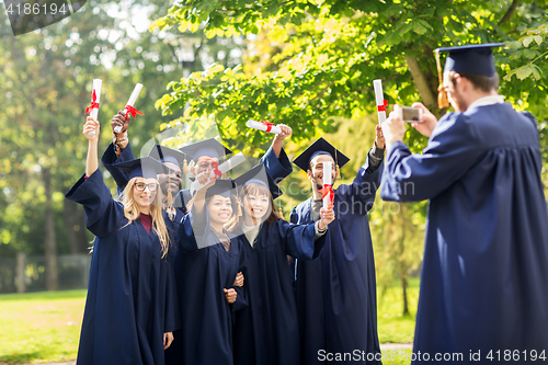 Image of students or bachelors photographing by smartphone