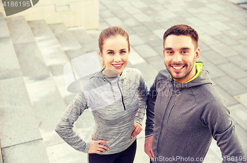 Image of smiling couple outdoors on city street
