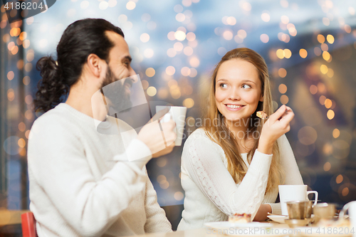 Image of happy couple meeting and drinking tea or coffee