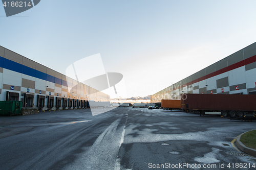 Image of warehouse gates and trucks loading