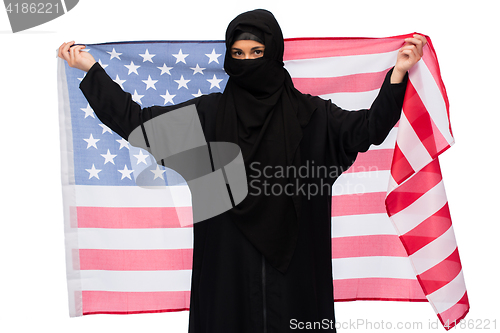 Image of muslim woman in hijab with american flag