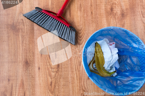 Image of rubbish bag with trash and cleaning items at home