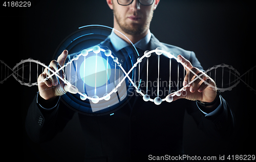 Image of close up of businessman with virtual dna molecule