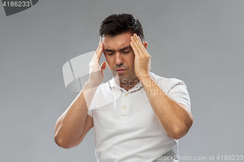 Image of unhappy man suffering from head ache