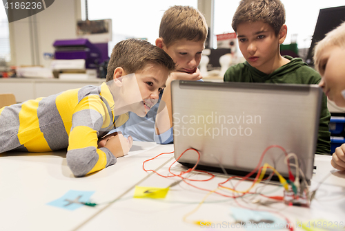 Image of kids, laptop and invention kit at robotics school