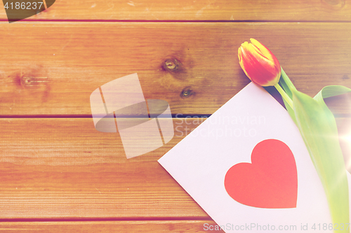 Image of close up of flowers and greeting card with heart