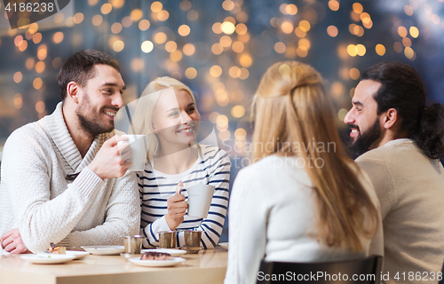 Image of happy friends meeting and drinking tea