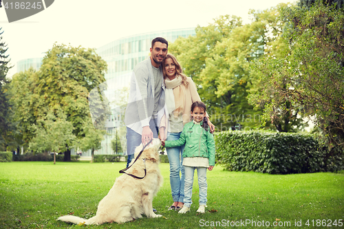 Image of happy family with labrador retriever dog in park