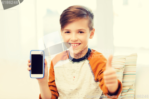 Image of smiling boy with smartphone at home