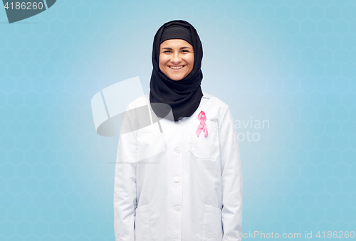 Image of muslim doctor with breast cancer awareness ribbon