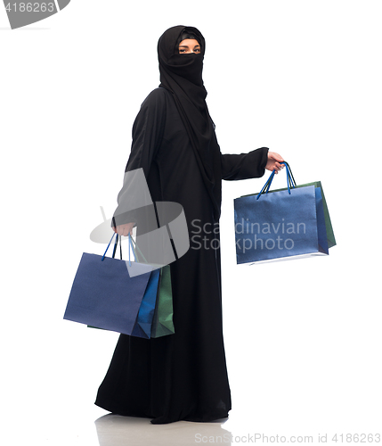 Image of muslim woman in hijab with shopping bags