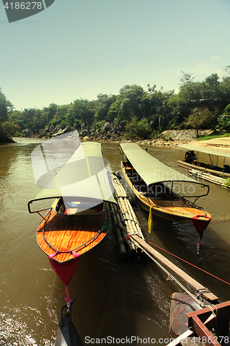 Image of Taxi boats near pier at sun day