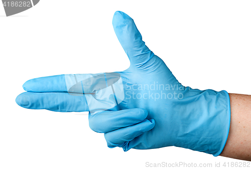 Image of Hand in blue latex glove fingers pistol