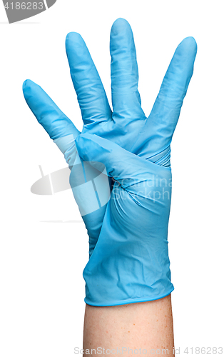 Image of Hand in blue latex glove showing four fingers