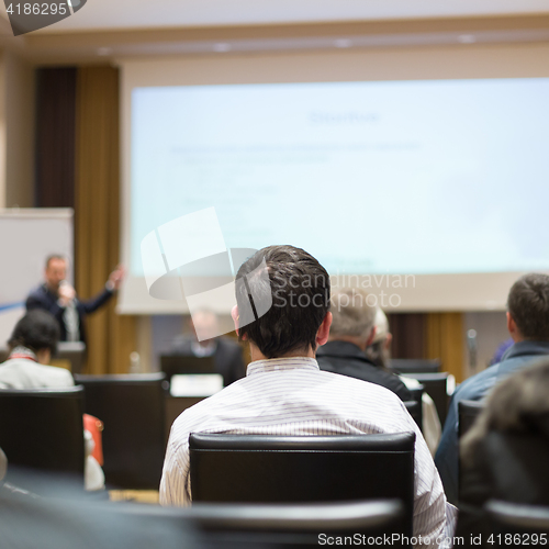 Image of Audience in lecture hall participating at business conference.