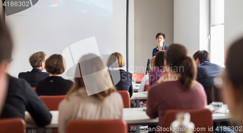 Image of Woman giving presentation in lecture hall at university.