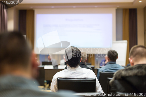 Image of Audience in lecture hall participating at business conference.