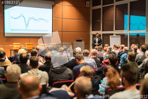 Image of Business speaker giving a talk in conference hall.