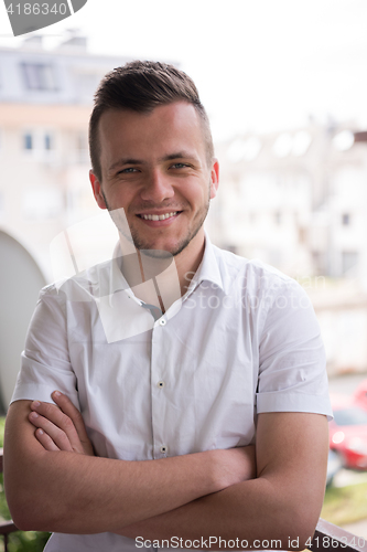 Image of man standing at balcony