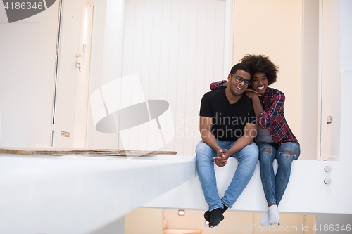 Image of couple having break during moving to new house