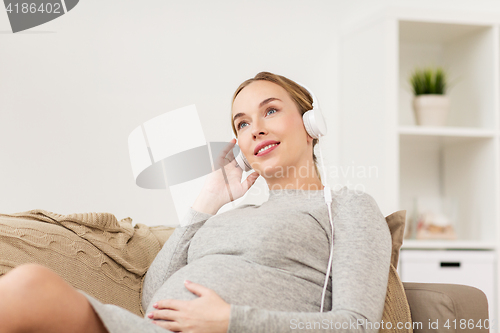 Image of pregnant woman with headphones listening to music