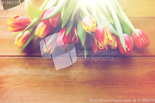 Image of close up of tulip flowers on wooden table