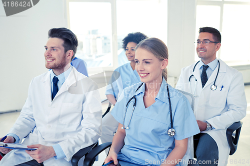 Image of group of happy doctors on seminar at hospital