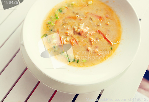 Image of close up of cream soup plate on table