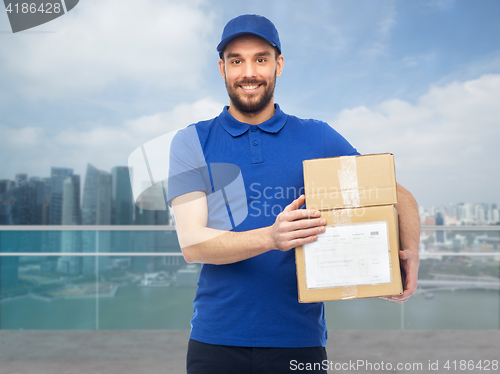 Image of happy delivery man with boxes over singapore city