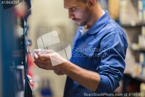 Image of auto mechanic or smith at workshop or warehouse