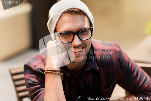 Image of happy smiling man in eyeglasses and hipster hat