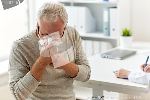 Image of senior man blowing nose with napkin at hospital