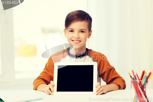 Image of smiling boy showing tablet pc blank screen at home