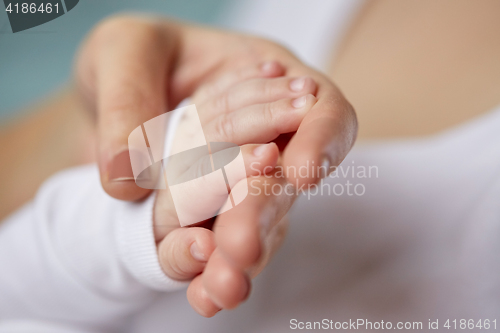 Image of close up of mother and newborn baby hands