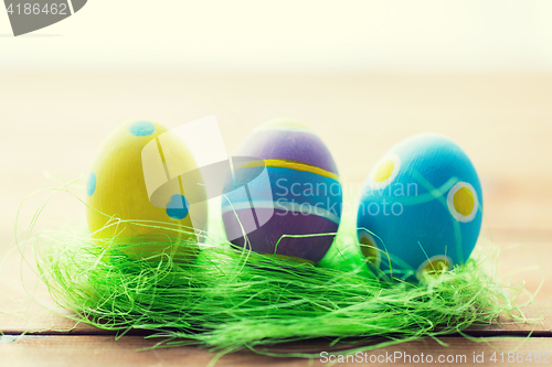 Image of close up of colored easter eggs and grass