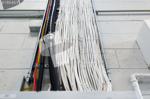 Image of group of electricity cables at wall