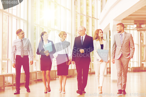 Image of business people walking along office building