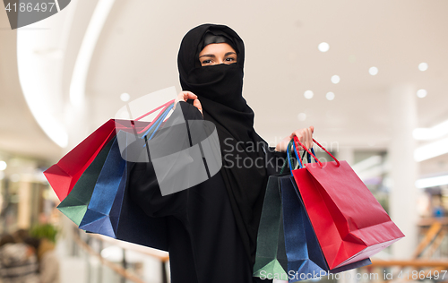 Image of muslim woman in hijab with shopping bags