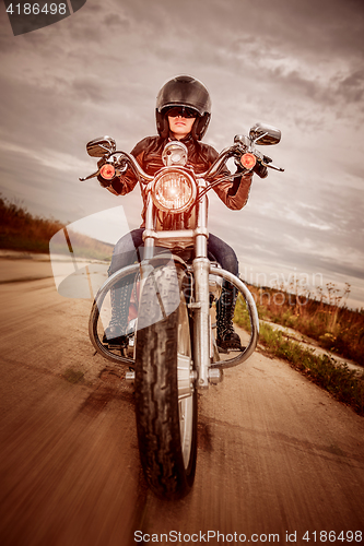 Image of Biker girl on a motorcycle