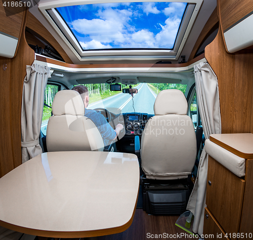 Image of Man driving on a road in the Camper Van