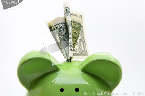 Image of Green piggy bank with US dollar bills