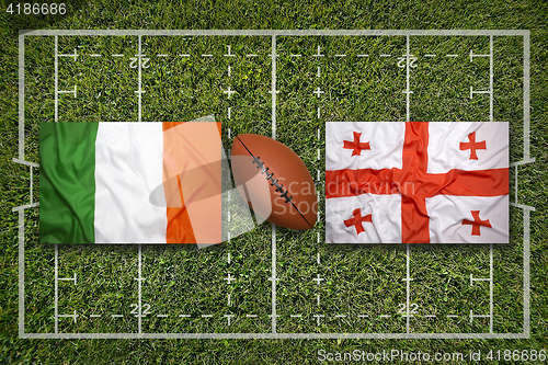 Image of Ireland vs. Scotland\r\rIreland vs. Georgia flags on green rugby f