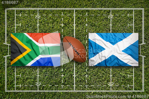 Image of South Africa vs. Scotland flags on rugby field