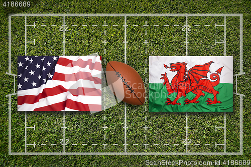 Image of USA vs. Wales flags on rugby field